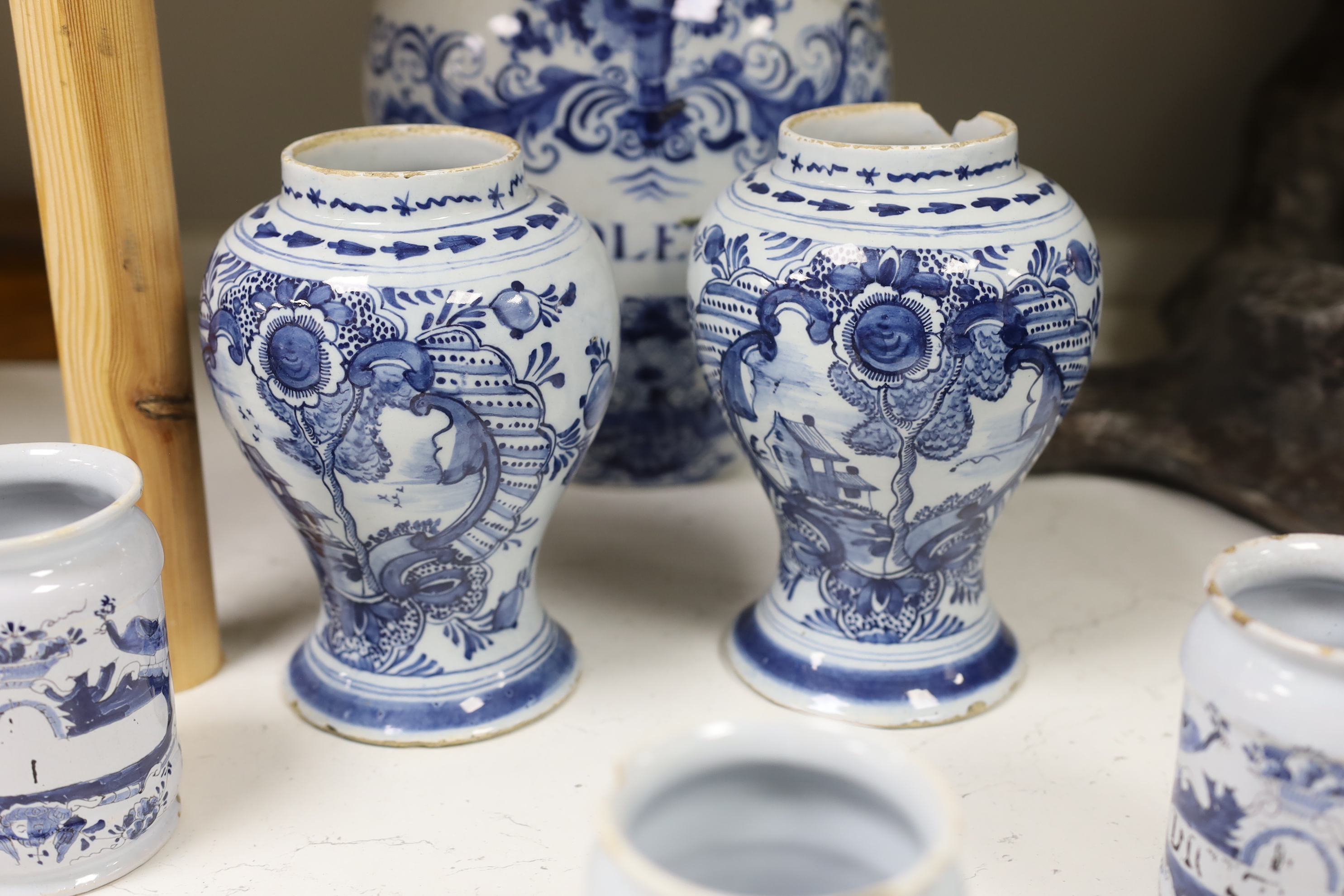 A set of three 18th century Delft drug jars, a similar large Violetta jar, Duyn mark, and a pair of 18th century Delft vases, tallest 28cm high